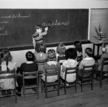 32nd street school activities.  Children learning words they need to know in order to write about their airplanes. (Lower elementary)