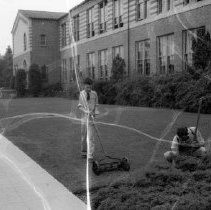 32nd street school activities.  Custodian working on grounds.