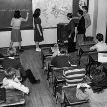 Burroughs Jr. High School activities.  Students listening to news broadcast