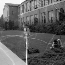 32nd street school activities.  Custodian working on grounds.