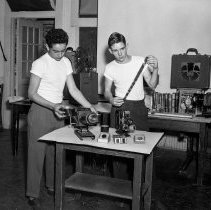 Bancroft junior high school activities.  Two boys demonstrating slide and still film projectors.