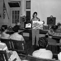 Bancroft junior high school activities.  Boy comparing book with larger picture.