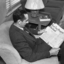 Consumer interest committee of the Los Angeles city defense council at North Hollywood high school.  Reading newspaper to keep informed of the latest news.