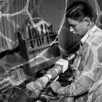 Wiggins, Frank trade school activities.  Woodwork class student working on lathe.