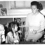 Miss Rosemary Peterken, a foreign exchange teacher from Torquay, Devon, England, assists two of her American students --Kevin Meadows and September Fogel --in a reading readiness exercise.  Under the exchange program, Miss Peterken is teaching kindergarten this year at Cahuenga Elementary School.