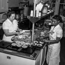 Dayton Heights Elementary School activities.  Health program.  Classroom showing background of blackboard exhibits of pictures and charts.  [Cafeteria staff making meals in the kitchen.]