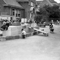 Nora Sterry Elementary School.  [Children playing on ship made out of wooden boxes on the playground.]