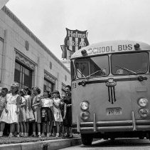 White Point Elementary School activities.  School journey.  Children take a trip through Helms bakery. [Coming off of a school bus on a field trip.]
