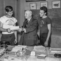 Los Angeles City High School students marketing sheep at the Los Angeles Union stockyards. Boys being presented with checks for their prize winning sheep.   [Future Farmer’s of America (FFA), Agriculture]