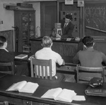 Roosevelt high school activities.  Manipulative model of gasoline engine being used in physics class to demonstrate the operation and construction of a gasoline engine. (Model made by WPA)