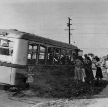 [Students getting on a school bus.]