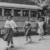 [Students getting off a school bus.]