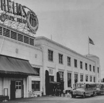 [Students getting off school bus for school journey or field trip through Helms Bakery.]