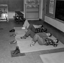 Washington Boulevard school, Elementary activities. Boys lying on mats.