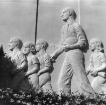 [Two bas reliefs show students walking with teachers]