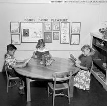 Summer classes at Chapman Avenue school.  Children reading in library corner.