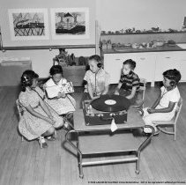 Summer classes at Chapman Avenue school.  Children listening [with headphones] to a [vinyl record] recording of a book.