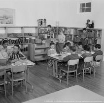 Elementary library activities, [Reading books].  Sherman Oaks elementary library with and without pupils.