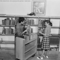 Elementary library activities, [Reading books].  Sherman Oaks elementary library with and without pupils.