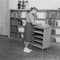 Elementary library activities, [Reading books, dictionary].  Sherman Oaks elementary library with and without pupils.