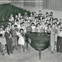 Sterry school activities.  Singing group [choir, music, orchestra, ensemble, teacher at piano].
