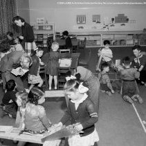 Pupils, teachers and student teachers in typical classroom situations.  Taken at Nora Sterry school. [Teachers supervising children with construction equipment.]