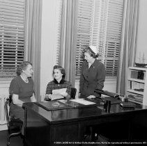 Nora Sterry school activities.  School nurse at her office desk alone, and inconference with P.T.A. [Parent Teacher Association, PTA] representative etc.