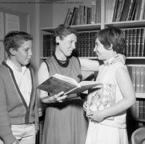 Class activities at Bellagio Road Elementary School.  Students and teachers are shown using the library facilities, music instruction, using audio visual equipment, playing musical instruments, and art.