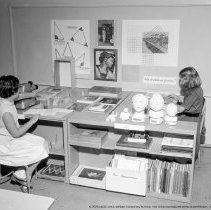 Class activities at Bellagio Road Elementary School.  Students and teachers are shown using the library facilities, music instruction, using audio visual equipment, playing musical instruments, and art.