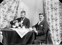 Two men having a cup of tea. T.E. Taylor studio, c.1896-1910.