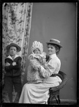 Portrait of a woman with two children. T.E. Taylor studio, c.1896-1910.