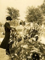 Woman in Black Standing Next to Casket in Cemetery