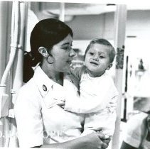 Miss Mary Harrigan, the HOPE Chief Nurse, playing and assisting in Peds.