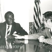 Dr. Walsh speak with Nigerian guest.