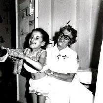 Sister Theophane Mandragos shares happy moment with a young patient.