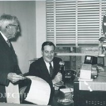 Dr. Walsh and Mr. Brundage relaying news to S.S. HOPE.