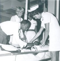 Dr Vendanayke and Carol Rymer with Pediatric patient on SS HOPE in Ceylon.