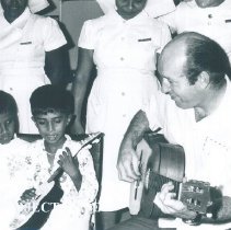 Charlie Byrd entertains pediatric patients on SS HOPE in Ceylon.
