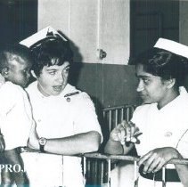 Maureen Gallagher Dever with counterpart and patient on SS HOPE Ceylon.