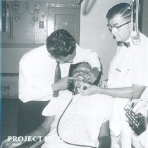 Harry Kavanaugh with counterpart and patient in the Dental Clinic in Ceylon