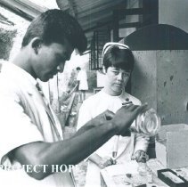 Grace Tucker, a registered nurse intructing a Ceylonese Med Tech in Ceylon.