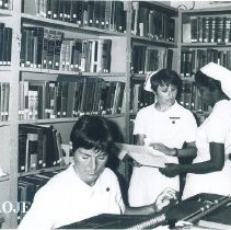 Harriet Weller and Joelyn Bymoen in Library on the SS HOPE in Ceylon.
