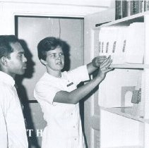 Jan Nugent and counterpart in Medical Records on the SS HOPE in Ceylon.