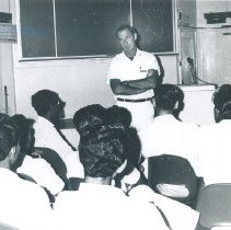 Everett McClintock giving lecture to med student while in Ceylon.