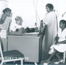 Robin Radin and interpreters at Admissionsdesk on the SS HOPE in Ceylon.
