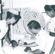 Barry Panter and Mary Lou Panter with patient on the SS HOPE in Ceylon.
