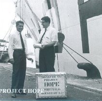 William Peters accepts a donation of tea while the SS HOPE was in port Ceyl