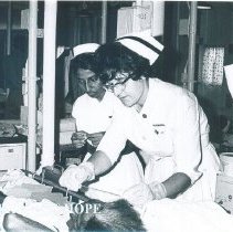 Annette Bisanz with counterpart and patient on the SS HOPE in Ceylon.