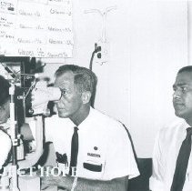 Charles Foote examines a patient with Ernest DeMil observing in Ceylon.