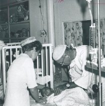 Robert Dripps and unknown nurse with patient on the SS HOPE in Ceylon.